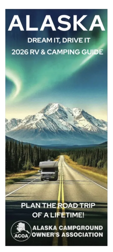 Printed Alaska campground map and guide open on a wooden table